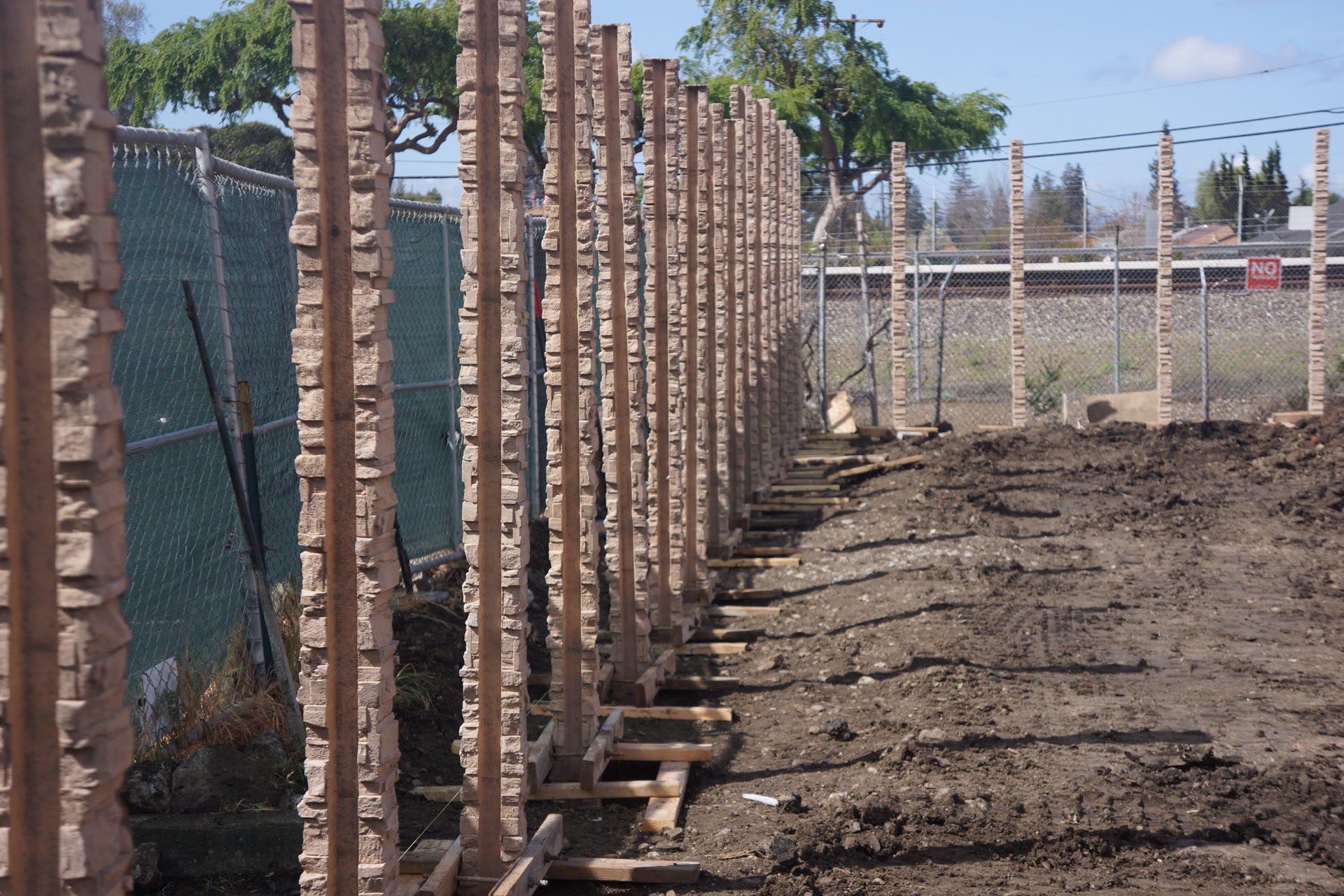 Precast concrete fence installation in progress